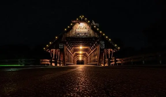 A covered bridge at night